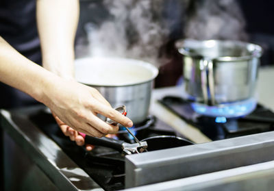 Midsection of man preparing food in workshop