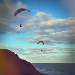 Hot air balloons flying over sea