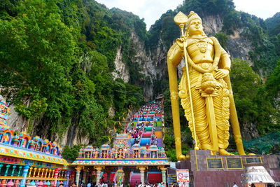 Statue of buddha against trees and plants