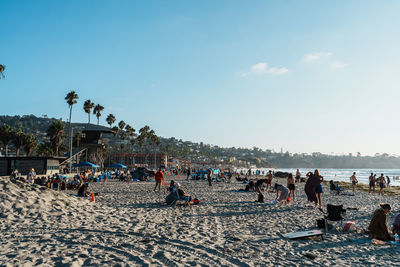 People at beach against sky