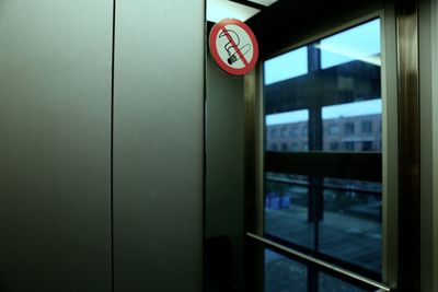 No smoking sign by glass window in building