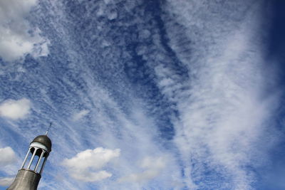 Low angle view of tower against cloudy sky