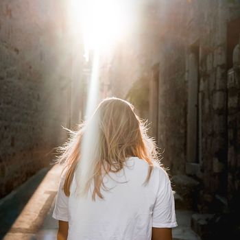 Rear view of woman in alley