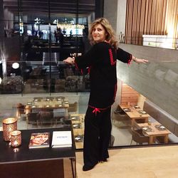 Full length of woman standing in illuminated store at night