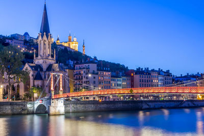 Bridge over river with buildings in background