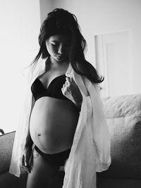 Pregnant woman standing at home