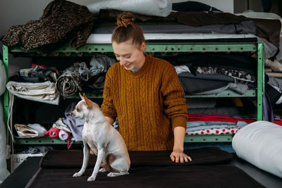 Woman and dog standing in garment factory