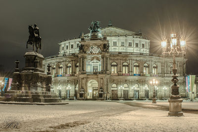 Statue in city at night