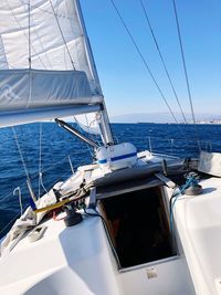 Sailboat sailing on sea against sky