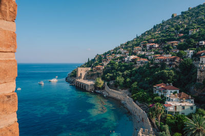 High angle view of townscape by sea against sky