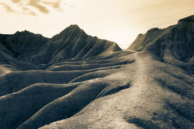 Scenic view of arid landscape against sky