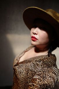 Mid adult woman wearing hat and red lipstick