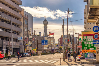 City street and buildings against sky