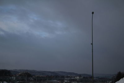 Storm clouds over electricity pylon