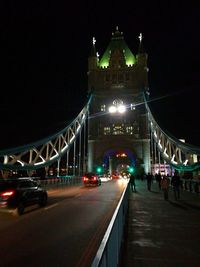 Illuminated bridge at night