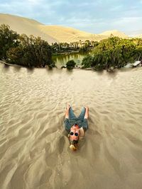 High angle view of woman on sand