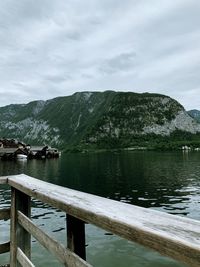 Scenic view of lake by mountains against sky