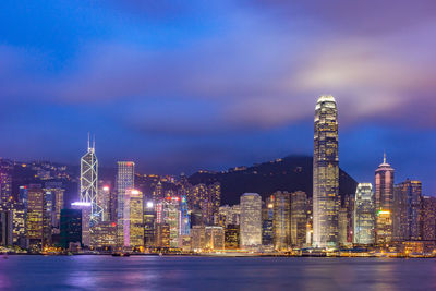 Illuminated buildings against sky at night