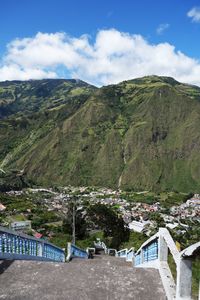 High angle view of town by mountains against sky