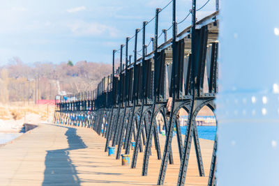 View of bridge in row against sky