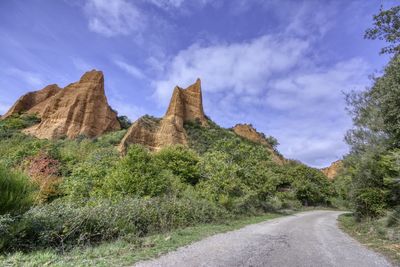 Road by mountain against sky