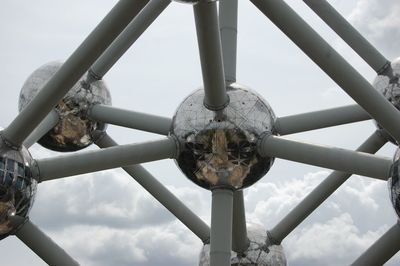 Low angle view of chain swing ride against sky