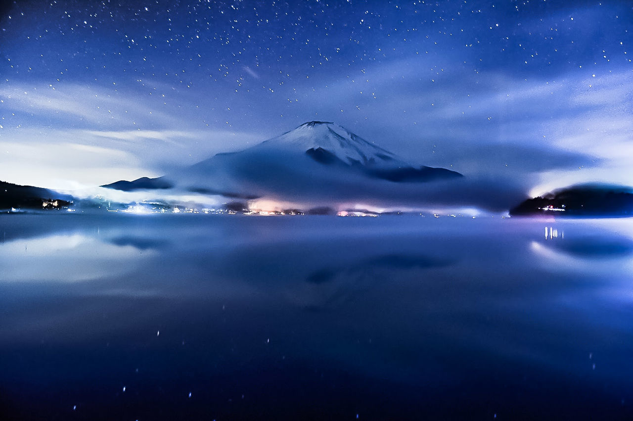 sky, night, scenics - nature, water, beauty in nature, star - space, tranquil scene, no people, tranquility, nature, mountain, cloud - sky, blue, sea, reflection, idyllic, illuminated, waterfront, space, outdoors, astronomy, snowcapped mountain