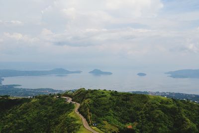 Scenic view of sea and mountains against sky