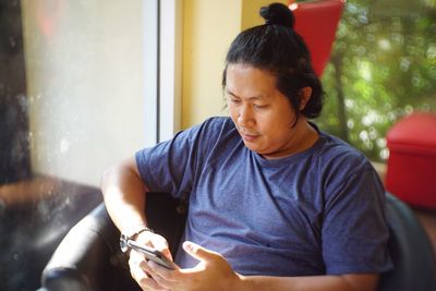 Full length of a man using mobile phone