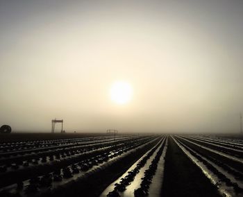 Scenic view of fog against sky during sunset