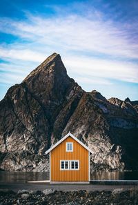 House on rock by building against sky