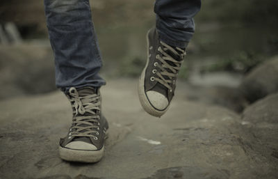 Low section of man standing on ground