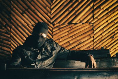 Low angle view of man sitting on floor