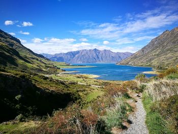 Scenic view of sea and mountains against sky