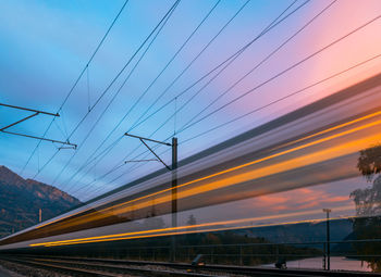 Low angle view of train against sky during sunset