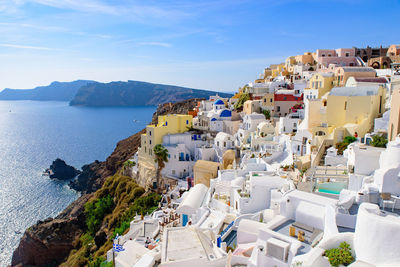 High angle view of townscape by sea against sky