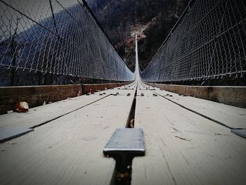 Close-up of footbridge against sky