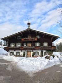 House on snow covered building against sky