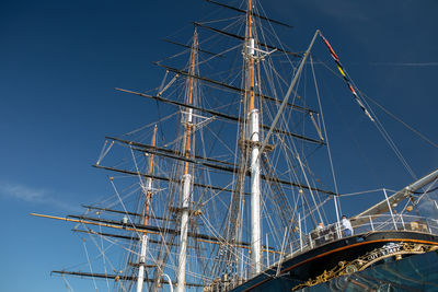 Low angle view of sailboat against blue sky