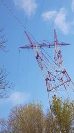 Low angle view of crane against sky