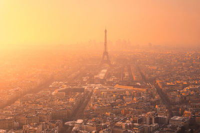 Aerial view of city district with residential buildings and eiffel tower on champ de mars in haze in paris