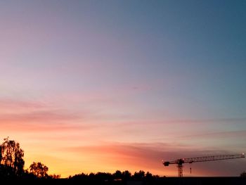 Silhouette trees against sky at sunset