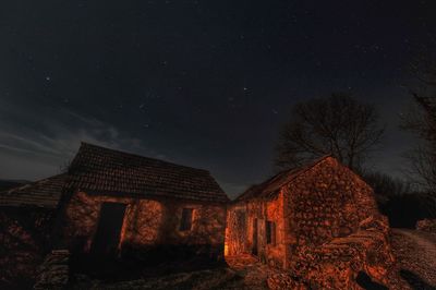 Low angle view of old building against sky at night