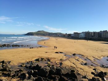 View of beach against blue sky