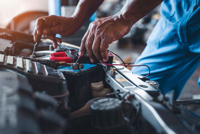 Midsection of man working at workshop