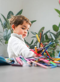 Portrait of boy playing with toys on table