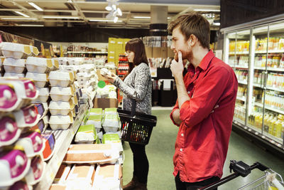 Man and woman shopping at supermarket