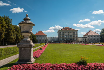 View of garden by building against sky