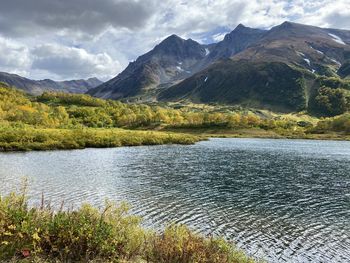 Scenic view of lake and mountains against sky