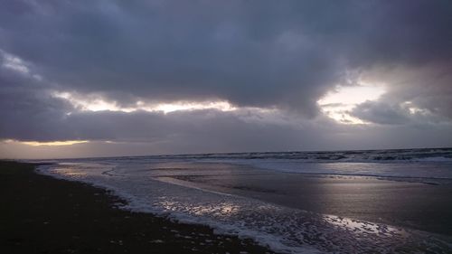 Scenic view of sea against cloudy sky